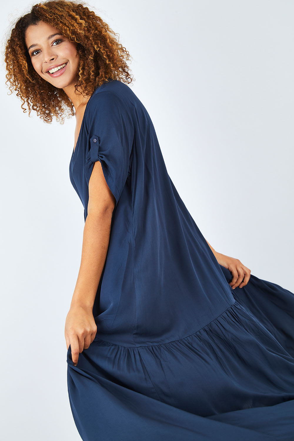 Model Summer wearing the Short Sleeve Peak Maxi Dress in colour Navy (Blue), from the front, cropped image