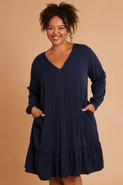 Model Alexis wearing the Long Sleeve Chic Dress in colour Navy (Blue), from the front, cropped image
