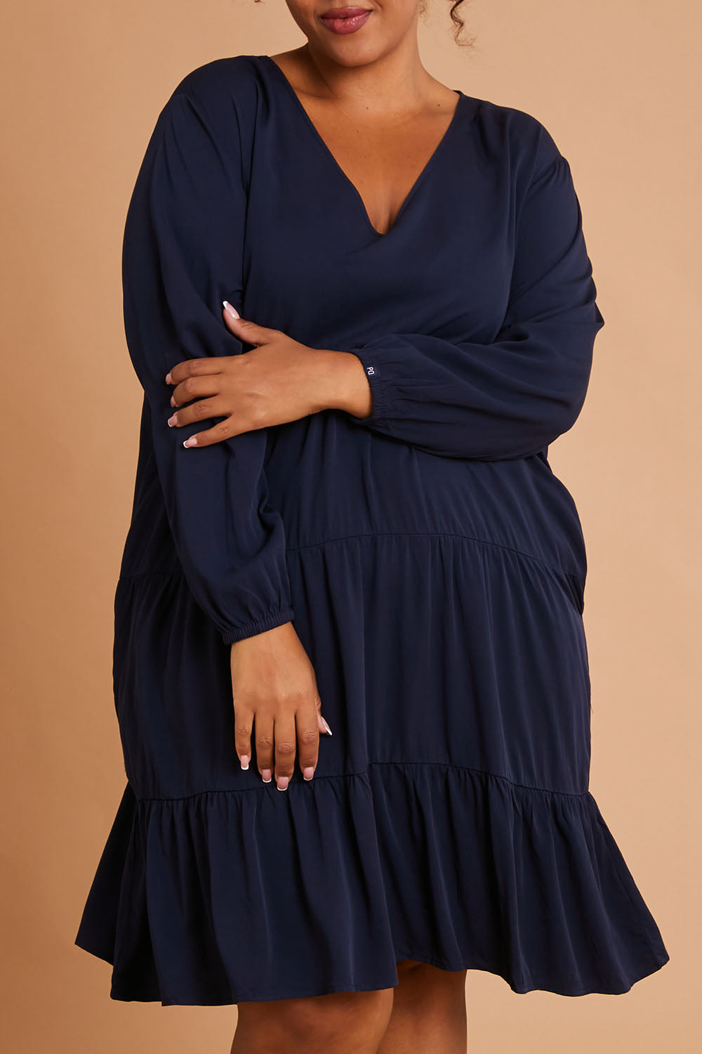 Model Alexis wearing the Long Sleeve Chic Dress in colour Navy (Blue), from the front, cropped image