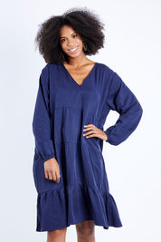 Model Schanez wearing the Long Sleeve Chic Dress in colour Navy (Blue), from the front, cropped image