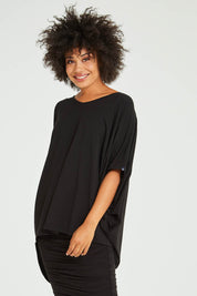 Model Olivia wearing size OneSize of the Hi Low Top in colour Black (Black), from the front, cropped image