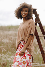 A model wearing the Hiin colourLow Miracle Top - Golddust (Metallics), from the front, showing the whole outfit
