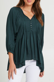 Model Madeline wearing size S of the Charlie Top in colour Peacock (Green), from the front, cropped image
