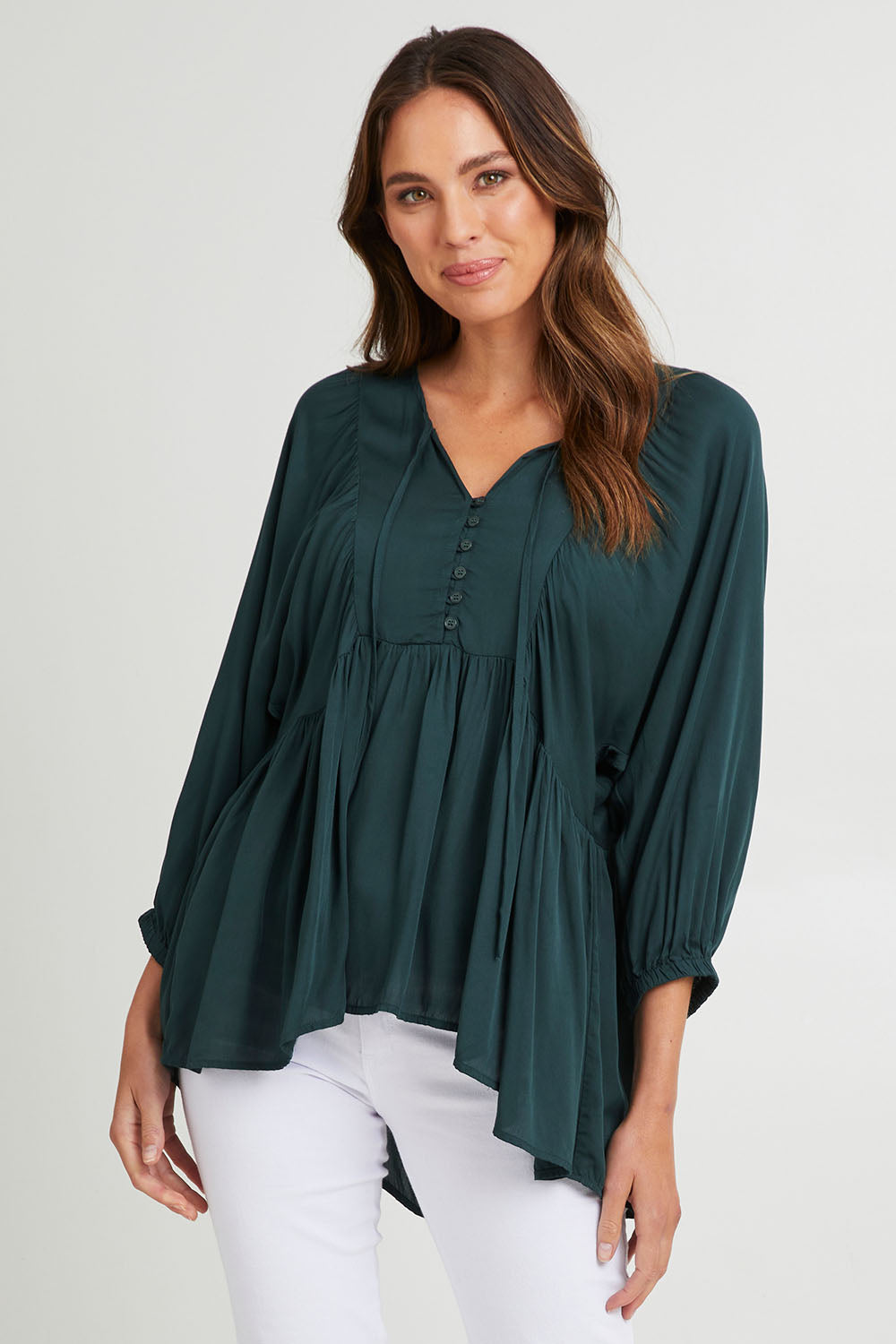Model Madeline wearing size S of the Charlie Top in colour Peacock (Green), from the front, cropped image