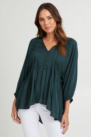 Model Madeline wearing size S of the Charlie Top in colour Peacock (Green), from the front, cropped image