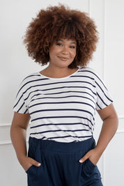 A model wearing the Destiny Top in colour Stripe (White), from the front, cropped image