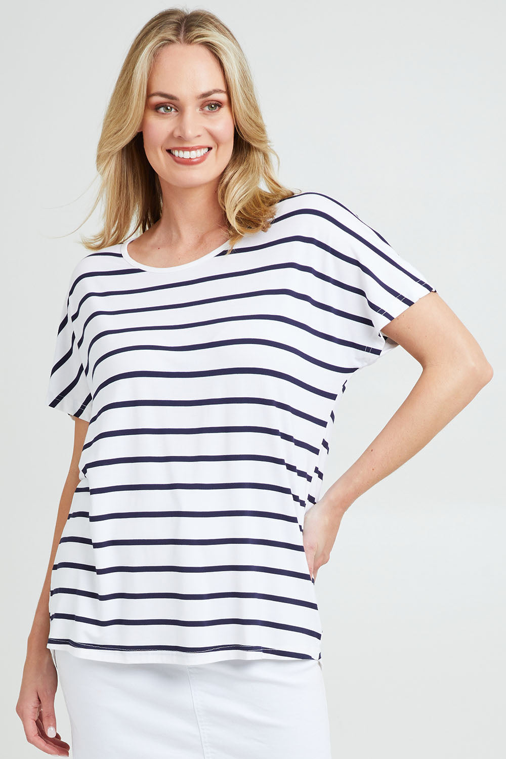 Model Grace wearing the Destiny Top in colour Stripe (White), from the front, cropped image
