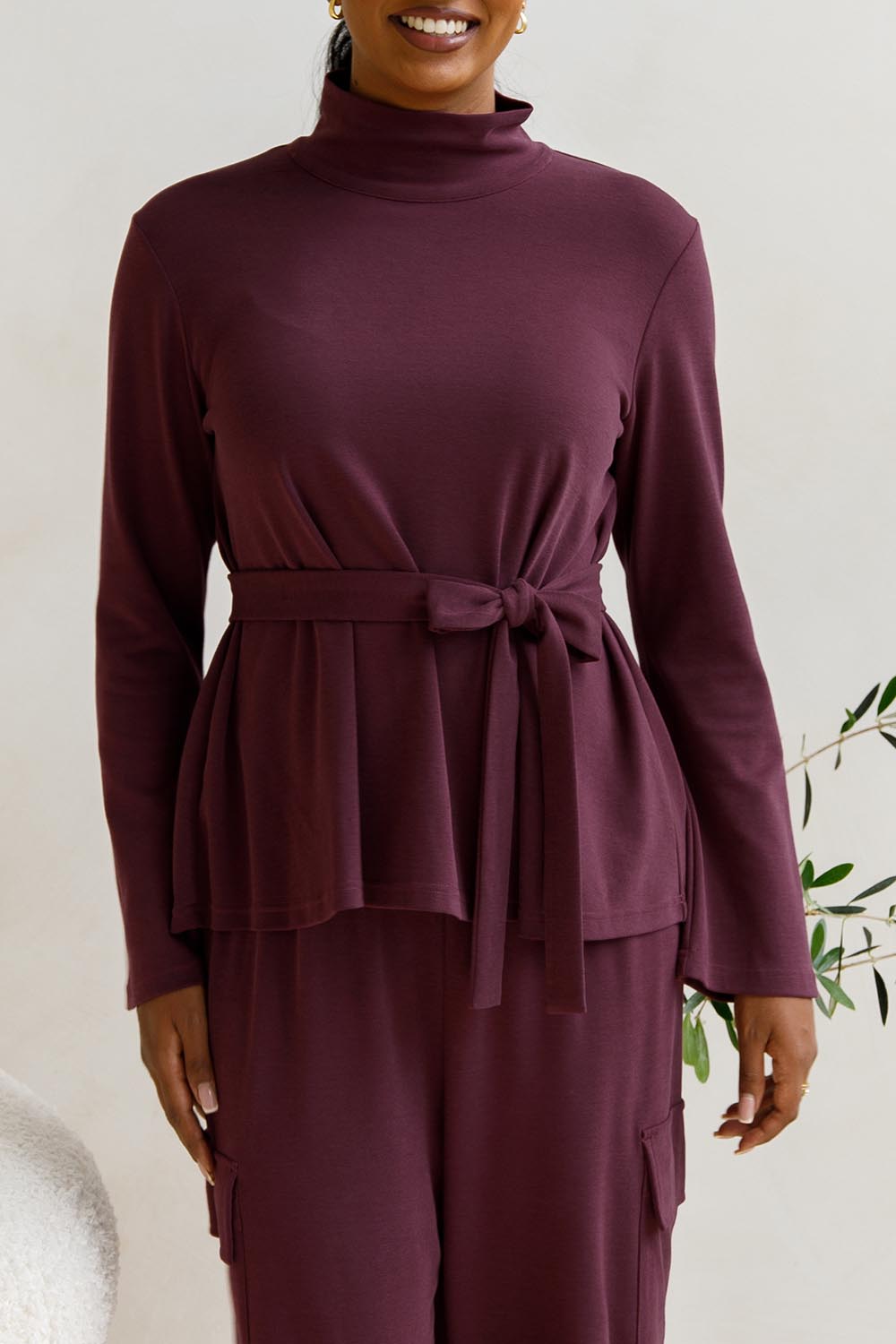 A model wearing the Jazmine Cotton Blend Top in colour Plum (Red), from the front, cropped image