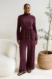 A model wearing the Jazmine Cotton Blend Top in colour Plum (Red), from the front, showing the whole outfit