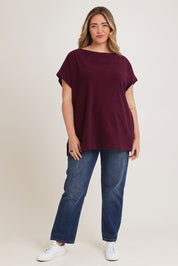 Model Chanel wearing size XL of the Bridget Top in colour Berry (Purple), from the front, showing the whole outfit