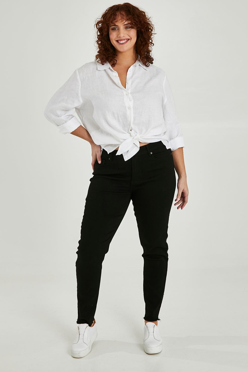 Model Maddy wearing size XXL of the Frayed Slim Fit Jean in colour Black (Black), from the front, showing the whole outfit