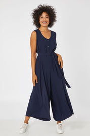 Model Olivia wearing the Button Down Jumpsuit in colour Navy (Blue), from the front, showing the whole outfit
