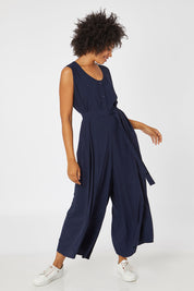 Model Olivia wearing the Button Down Jumpsuit in colour Navy (Blue), from the front, showing the whole outfit