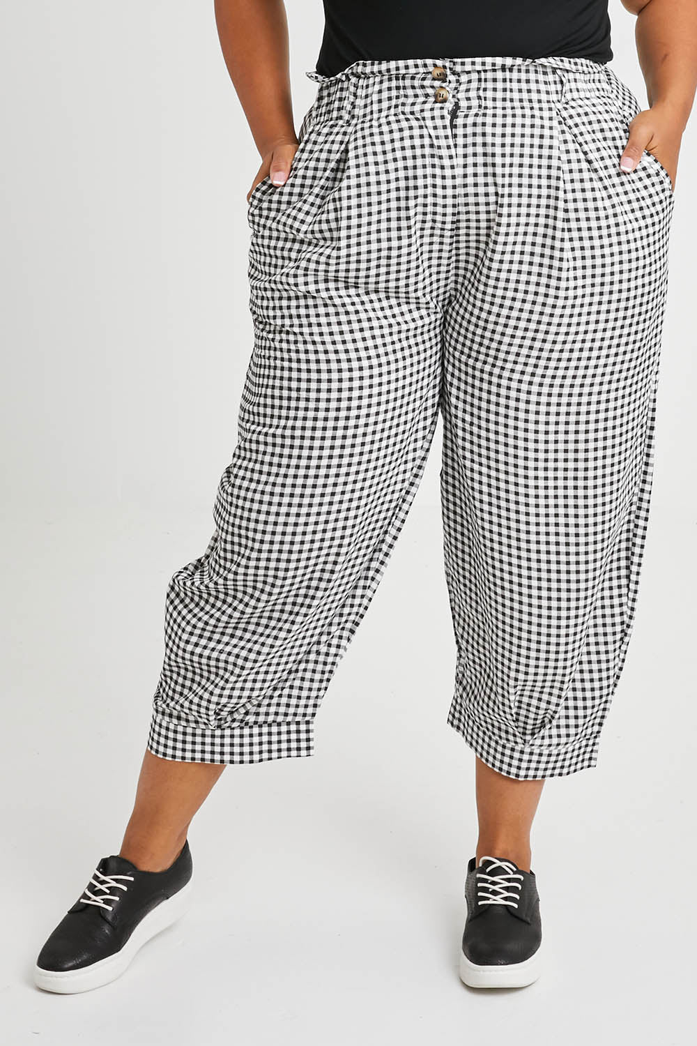 Model Alexis wearing size XL of the Archer Pant in colour Nightcheck (Blue), from the front, cropped image