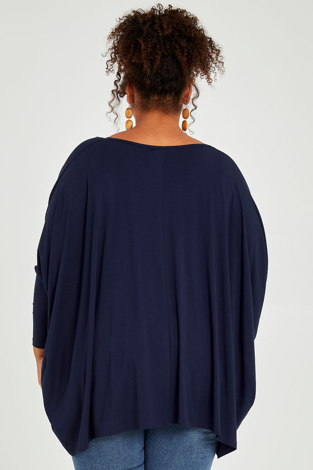Model Alexis wearing size OneSize of the Long Sleeve Essential Top in colour Navy (Blue), from the back