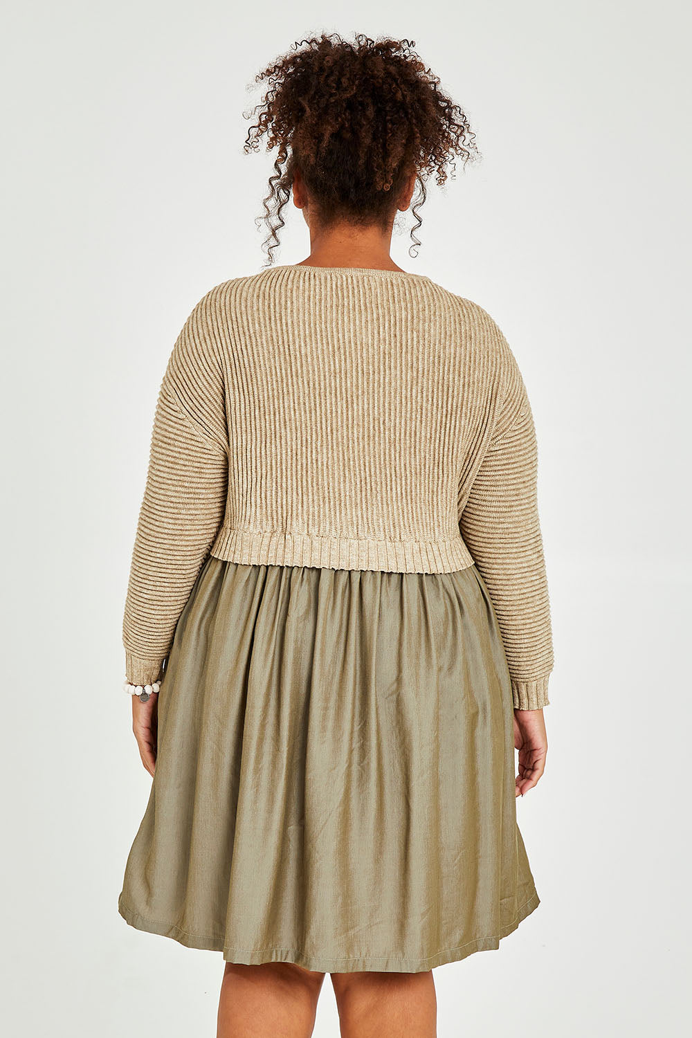 Model Alexis wearing the Lunar Knit Dress in colour Walnut (Green), from the back