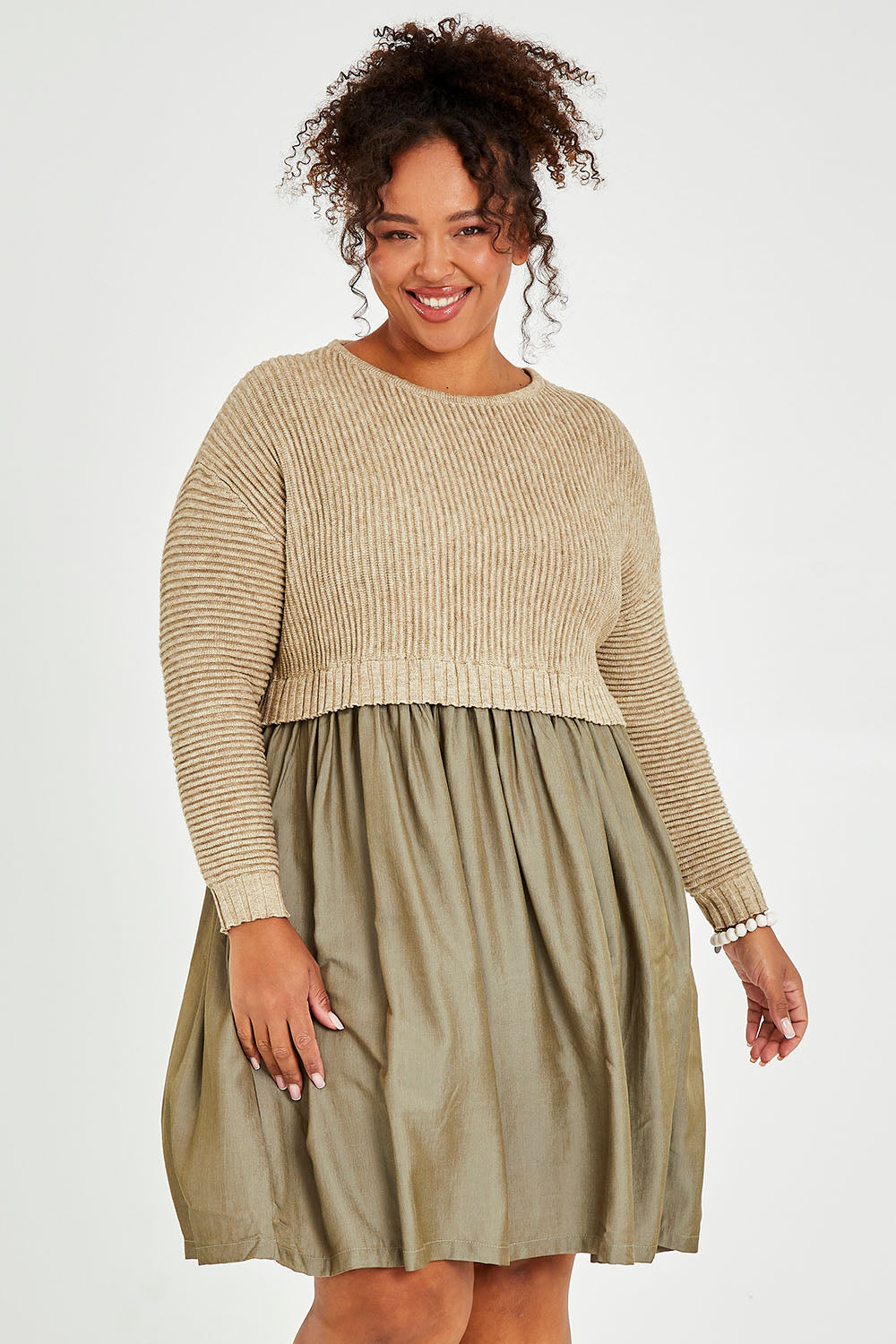 Model Alexis wearing the Lunar Knit Dress in colour Walnut (Green), from the front, cropped image