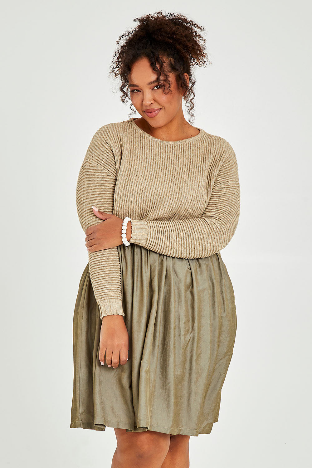 Model Alexis wearing the Lunar Knit Dress in colour Walnut (Green), from the front, cropped image