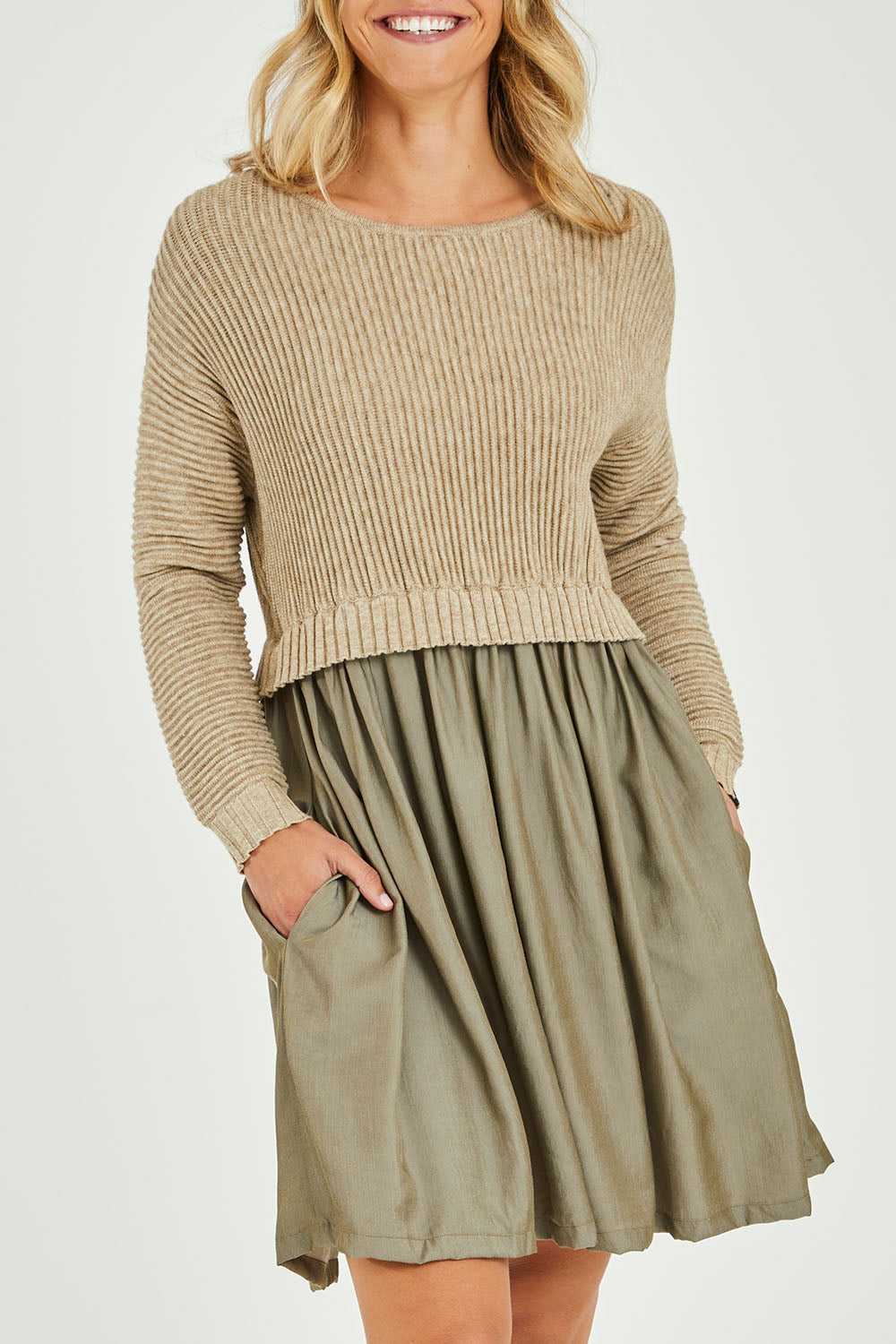 Model Alice wearing the Lunar Knit Dress in colour Walnut (Green), from the front, cropped image
