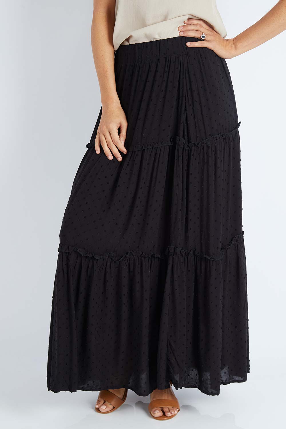 Model Gemma wearing size S of the Tier Maxi Skirt in colour Blackdot (Black), from the front, cropped image