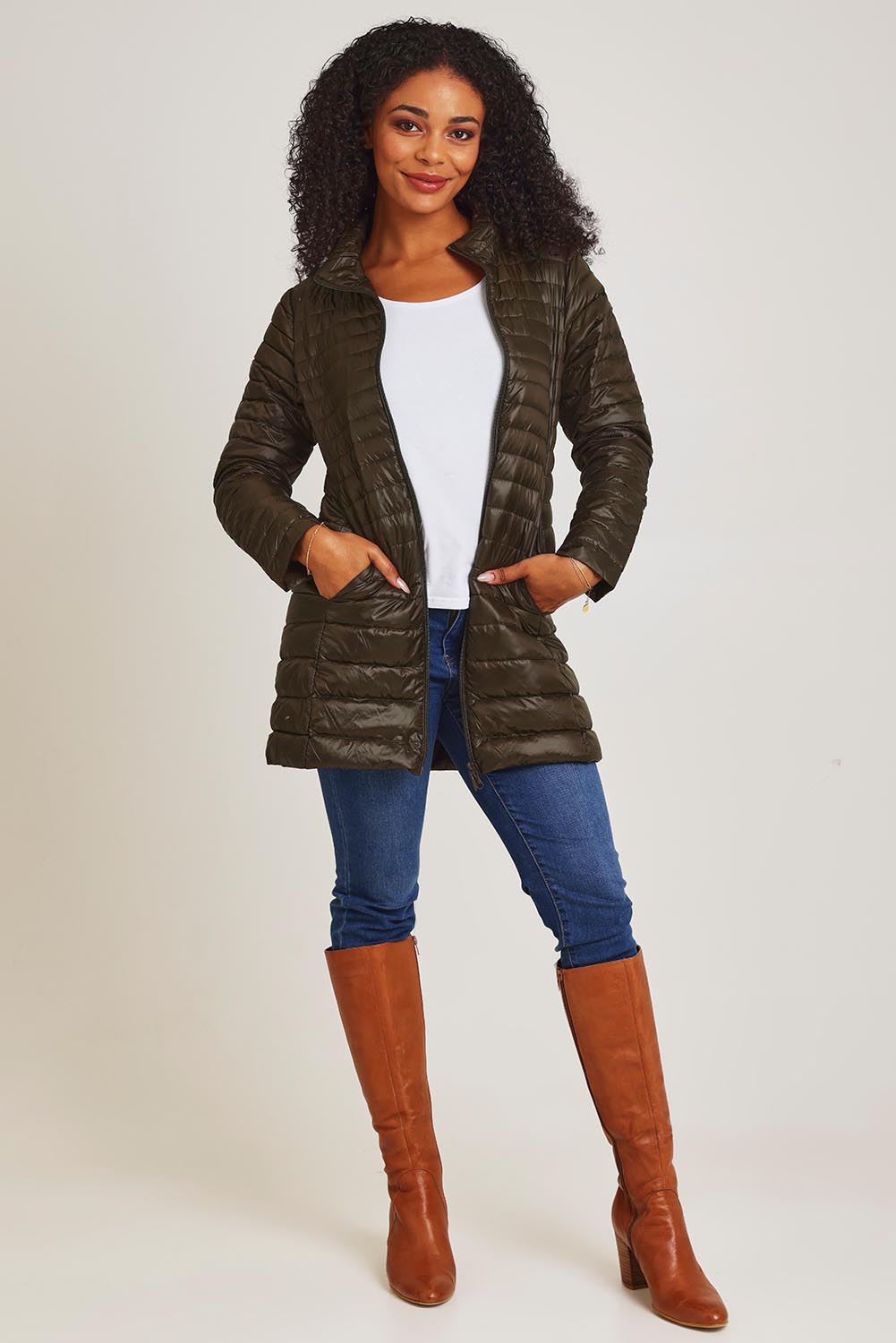 Model Ziara wearing size 10 of the Funnel Neck Down Jacket in colour Khaki (Green), from the front, showing the whole outfit