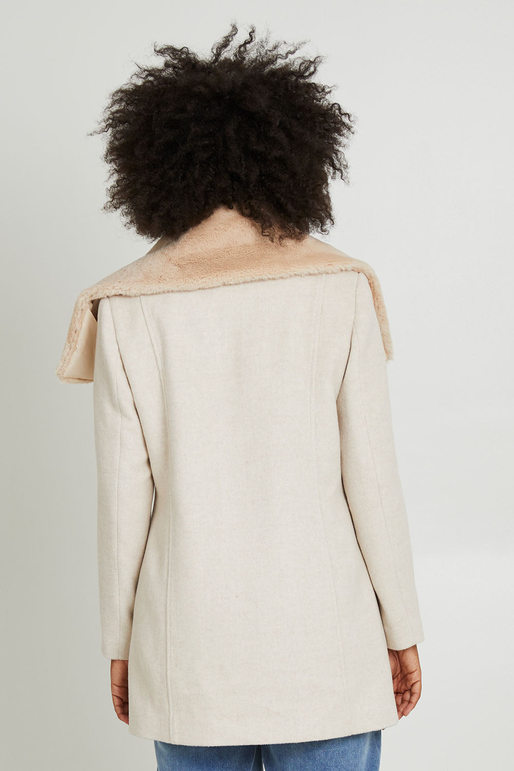 Model Olivia wearing size 10 of the Fur Trim Zip Jacket in colour Oat (White), from the back