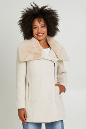 Model Olivia wearing size 10 of the Fur Trim Zip Jacket in colour Oat (White), from the front, cropped image