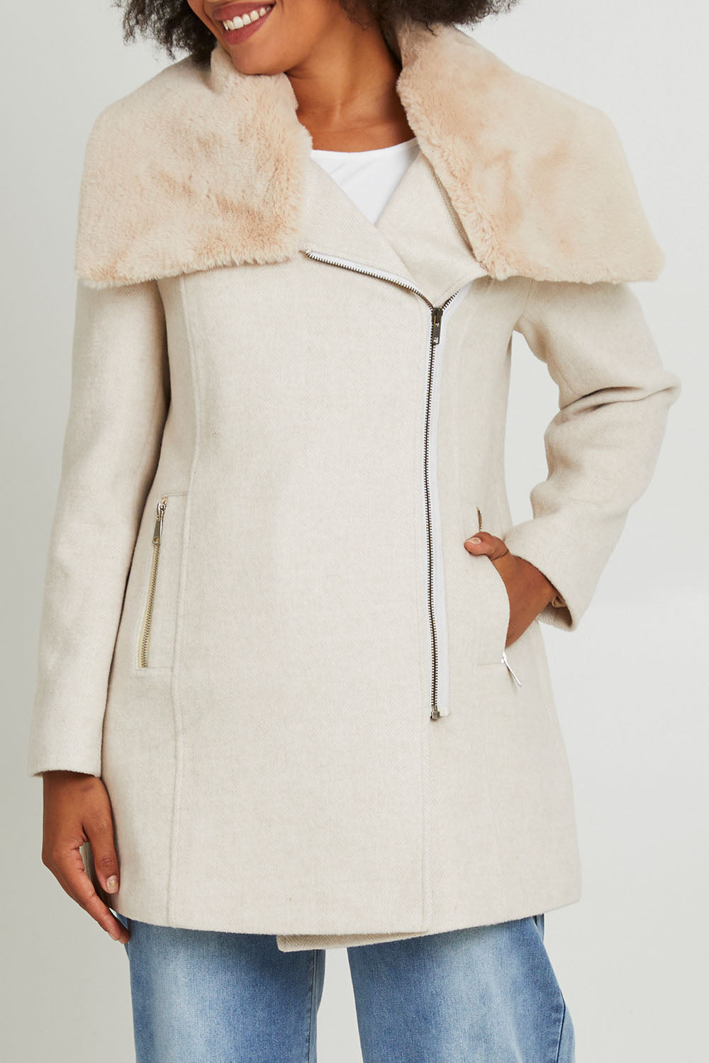 Model Olivia wearing size 10 of the Fur Trim Zip Jacket in colour Oat (White), from the front, cropped image