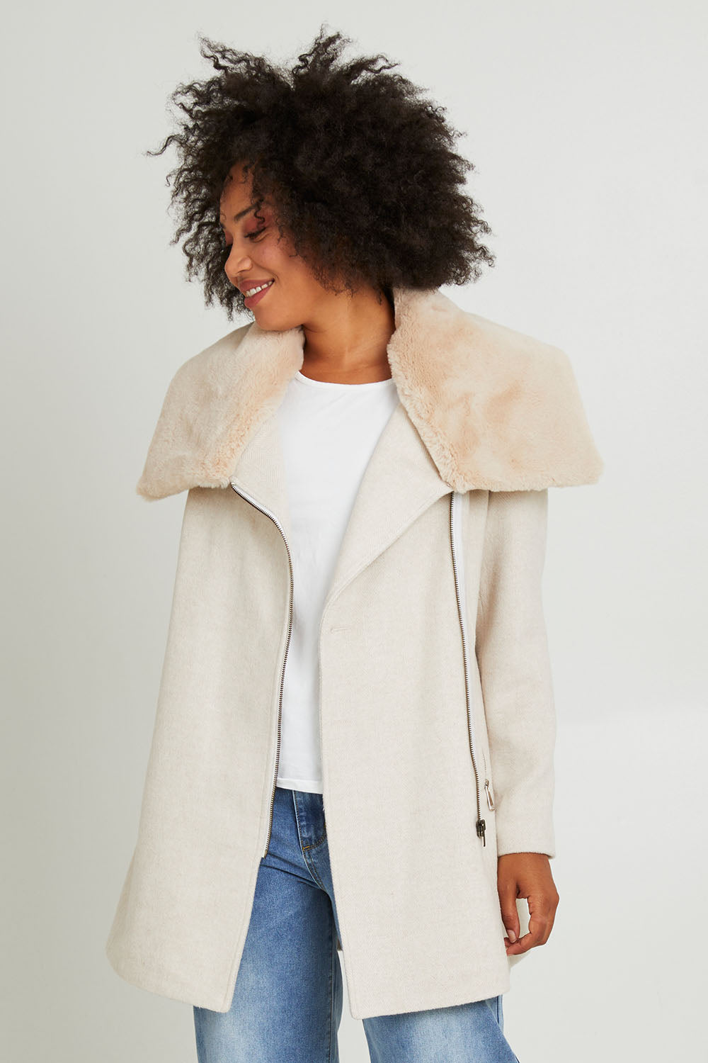 Model Olivia wearing size 10 of the Fur Trim Zip Jacket in colour Oat (White), from the front, cropped image