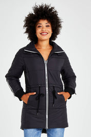 Model Olivia wearing size 10 of the Long Line Funnel Neck Puffer in colour Black (Black), from the front, cropped image
