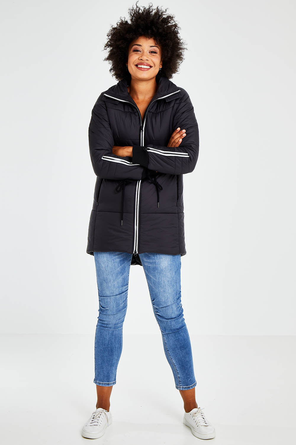 Model Olivia wearing size 10 of the Long Line Funnel Neck Puffer in colour Black (Black), from the front, showing the whole outfit