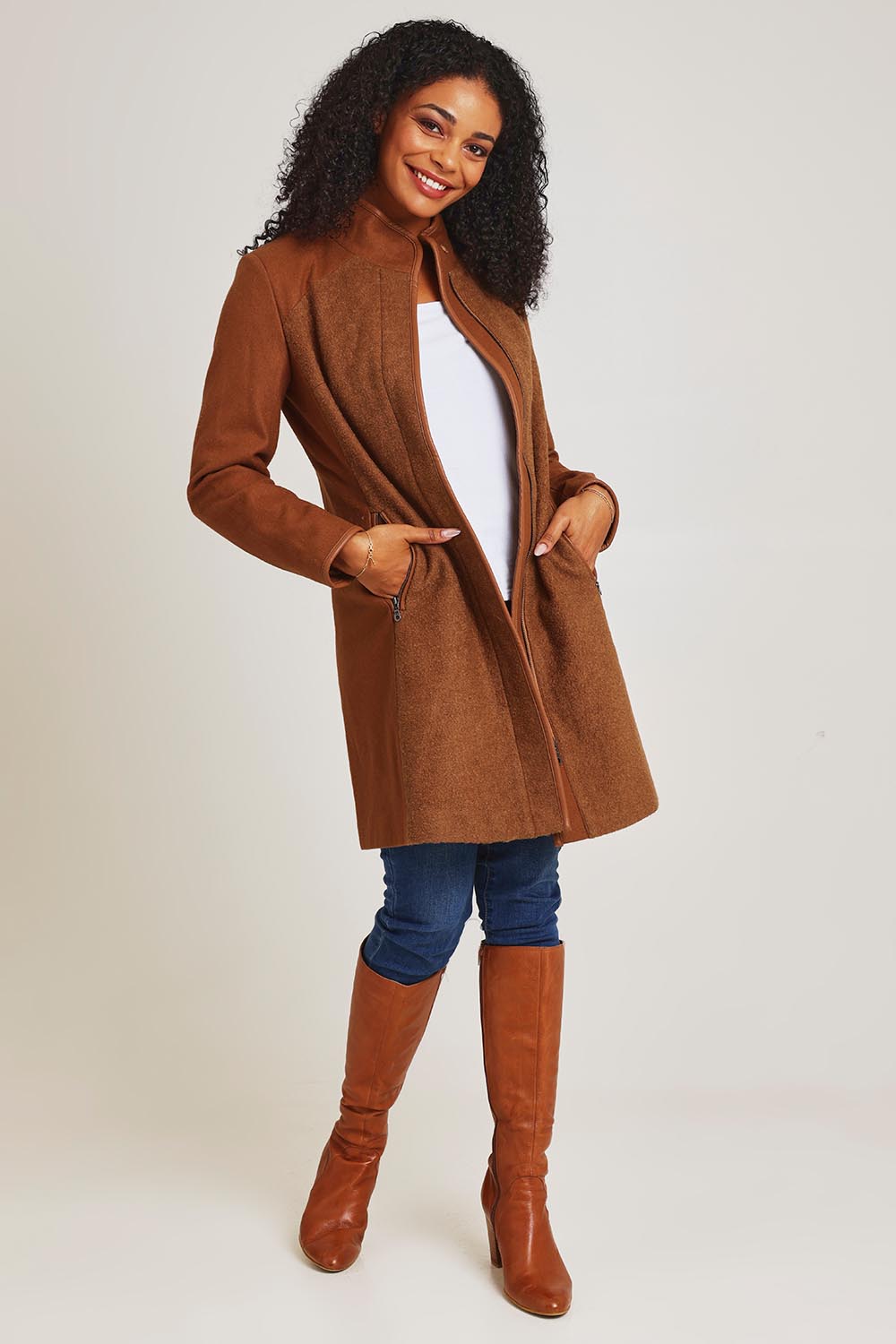 Model Ziara wearing size 10 of the Multi Fabric Jacket in colour Latte, from the front, showing the whole outfit