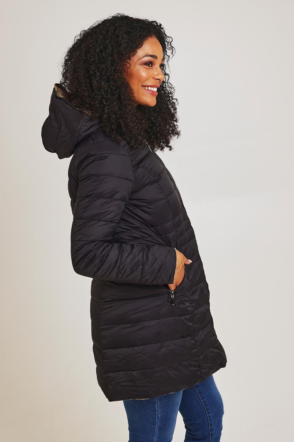 Model Ziara wearing size 10 of the 3/4 Reversible Down Jacket in colour Minkblk (Black), from the back