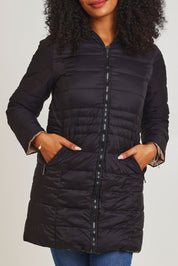 Model Ziara wearing size 10 of the 3/4 Reversible Down Jacket in colour Minkblk (Black), from the front, cropped image