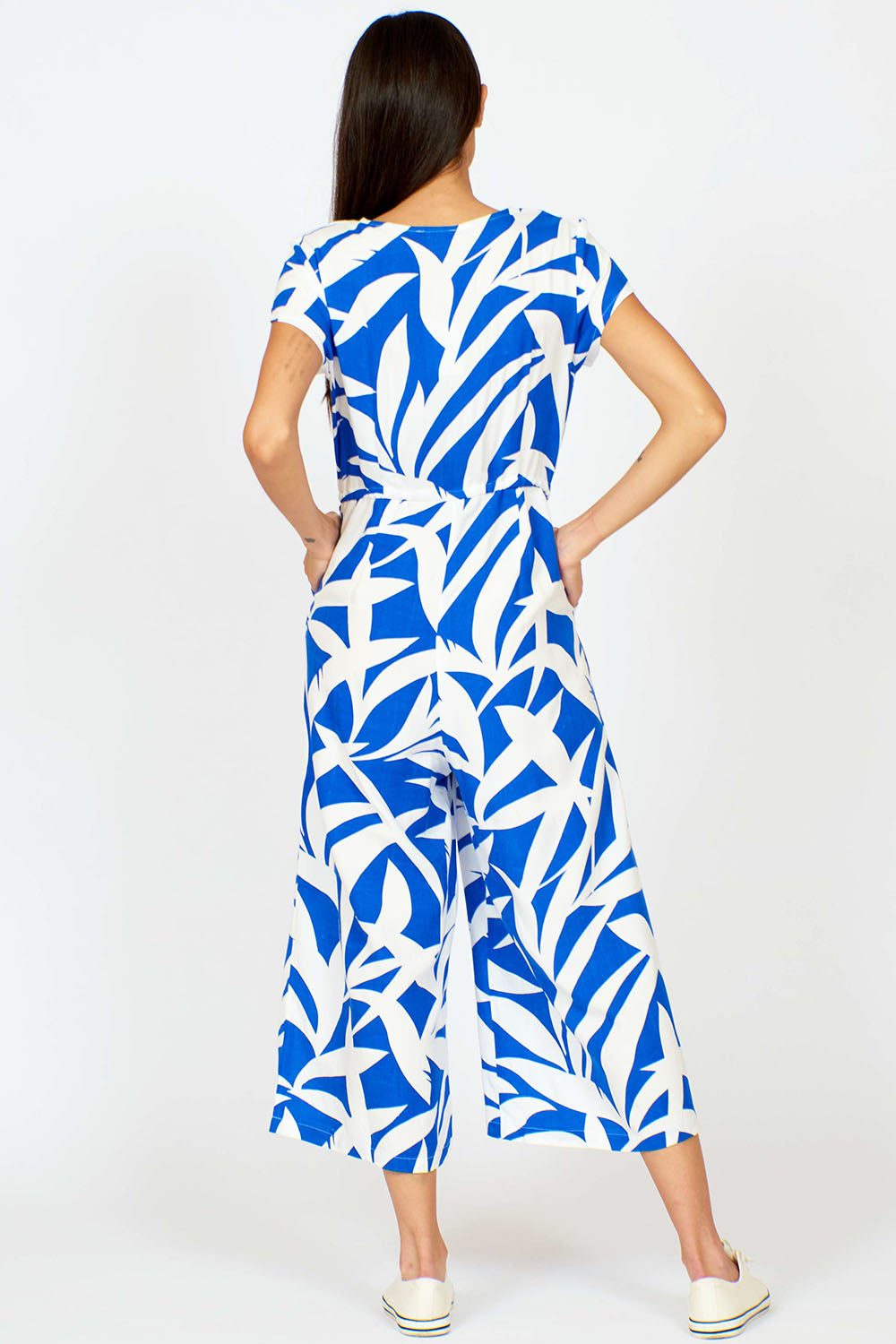 A model wearing the Fronds Playsuit in colour Fronds (Blue), from the back