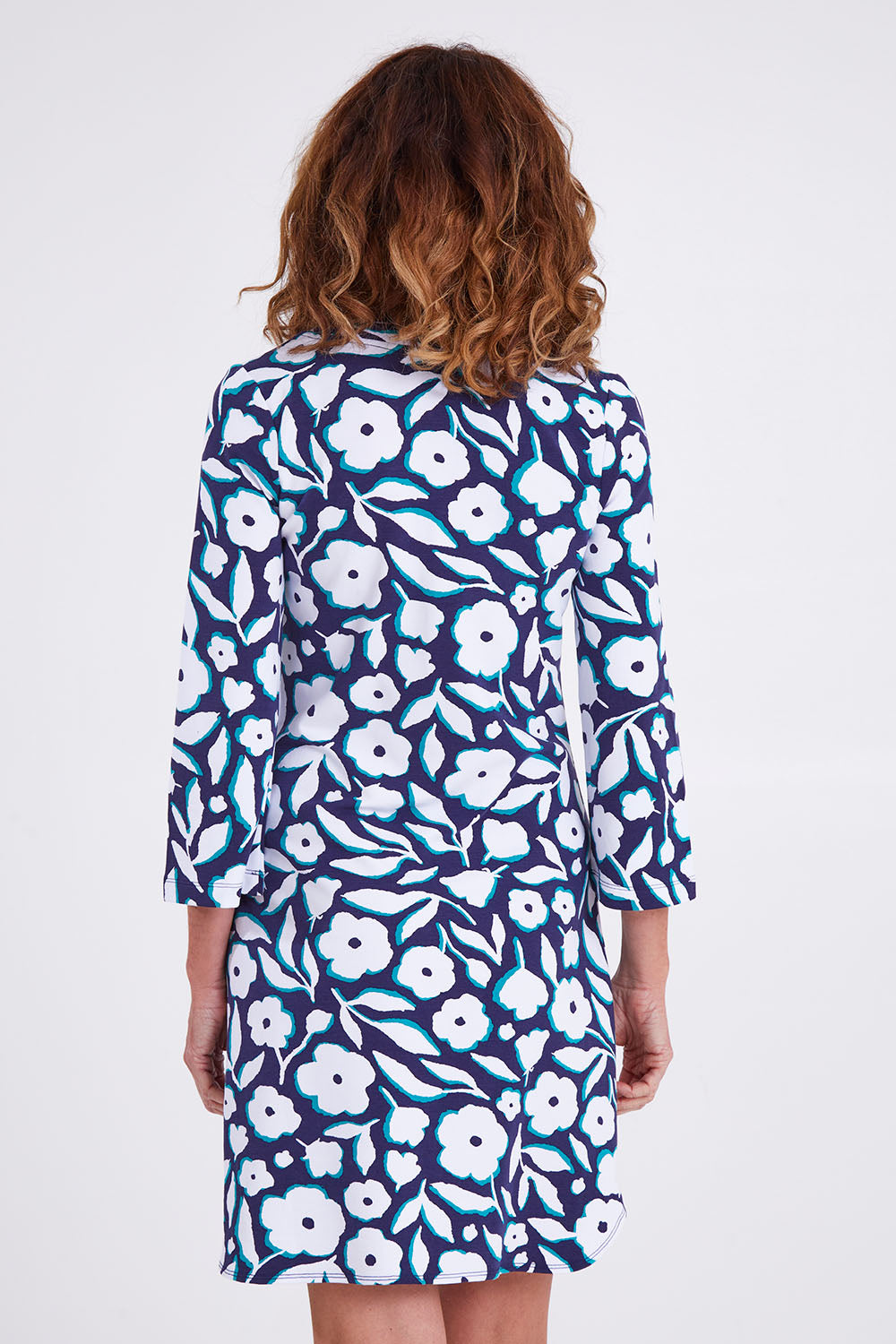 Model Emma wearing size S of the Ashley Dress in colour Flowers (Blue), from the back