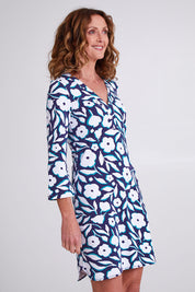 Model Emma wearing size S of the Ashley Dress in colour Flowers (Blue), from the front, cropped image