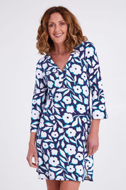 Model Emma wearing size S of the Ashley Dress in colour Flowers (Blue), from the front, cropped image