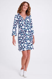 Model Emma wearing size S of the Ashley Dress in colour Flowers (Blue), from the front, showing the whole outfit