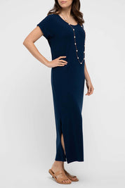 A model wearing the Elsie Dress in colour Navy (Blue), from the front, cropped image