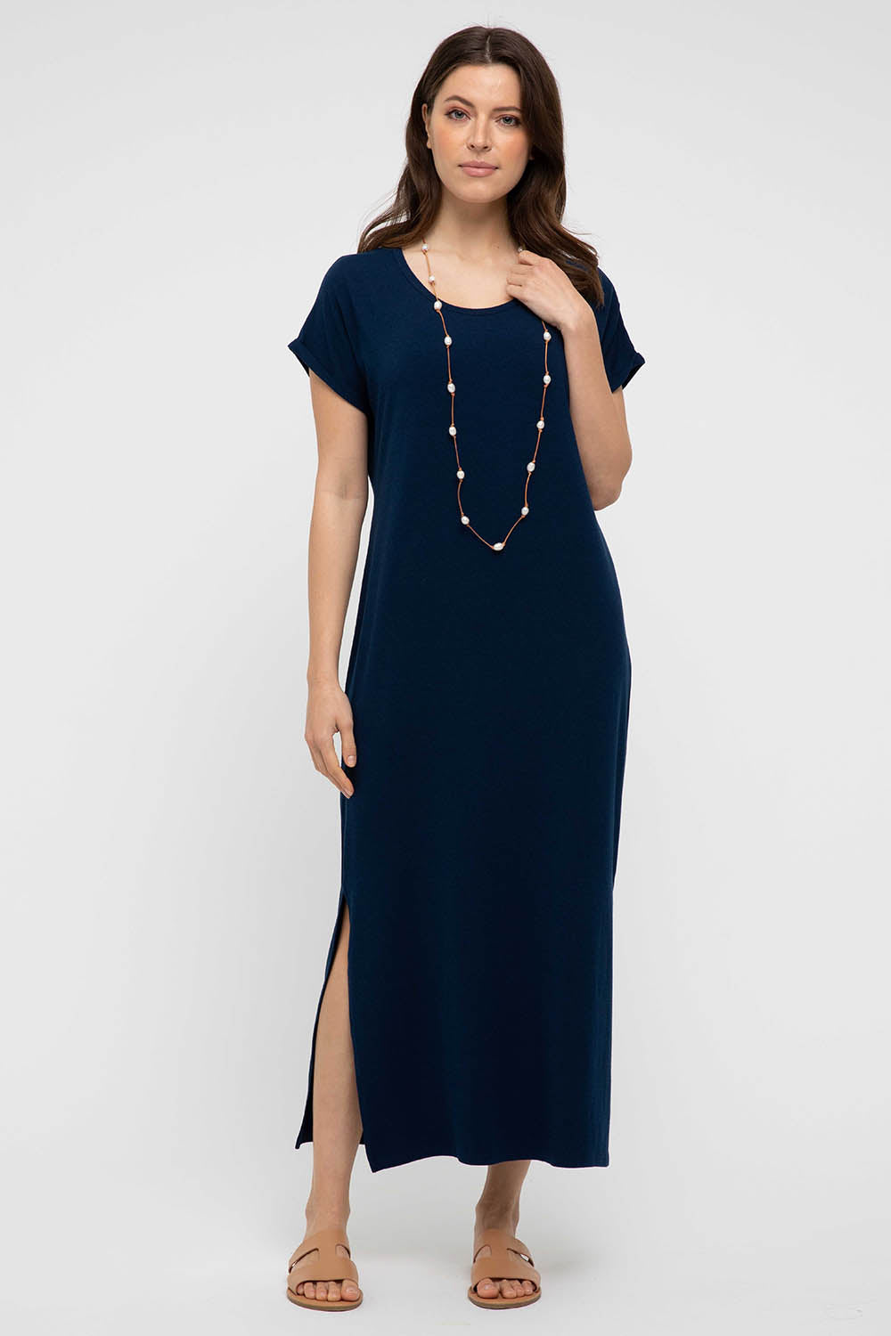 A model wearing the Elsie Dress in colour Navy (Blue), from the front, showing the whole outfit