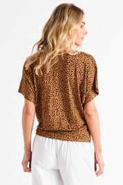 A model wearing the Maui Tee in colour Wildprint (Black), from the back