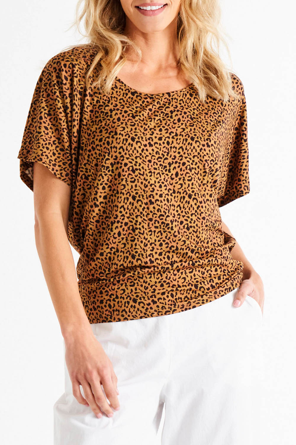 A model wearing the Maui Tee in colour Wildprint (Black), from the front, cropped image