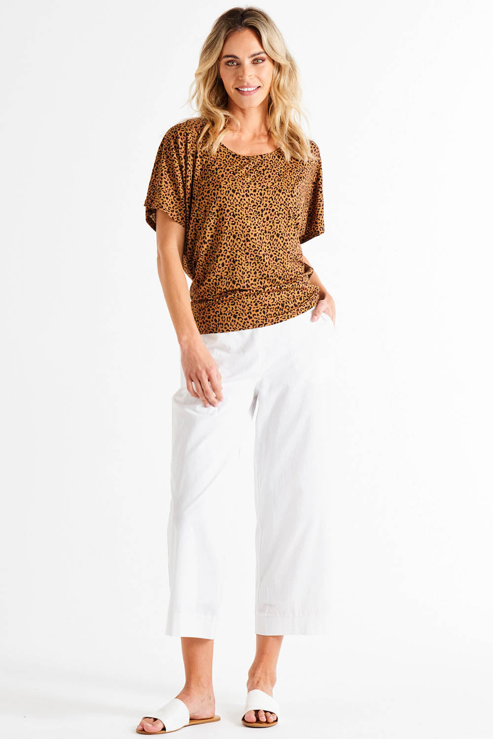 A model wearing the Maui Tee in colour Wildprint (Black), from the front, showing the whole outfit