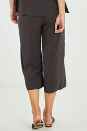 Model Alice wearing size 10 of the Alison Pant in colour Petrol (Black), from the back