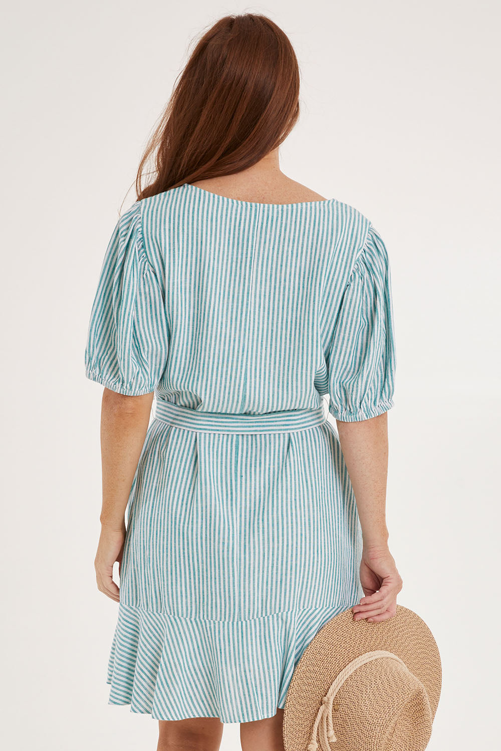 Model Sally wearing size 10 of the Birdie Dress in colour Tealstripe (Green), from the back