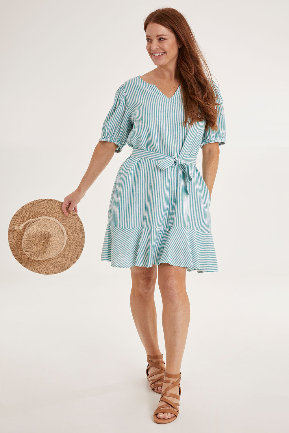 Model Sally wearing size 10 of the Birdie Dress in colour Tealstripe (Green), from the front, showing the whole outfit