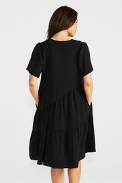 A model wearing the Florence Tiered Dress in colour Black (Black), from the back
