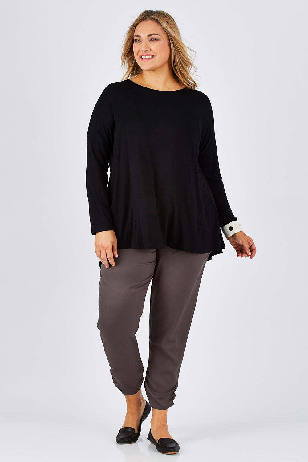 Model Ljubenka wearing size 18 of The Best Seller Pant in colour Castlerock (Green), from the front, showing the whole outfit