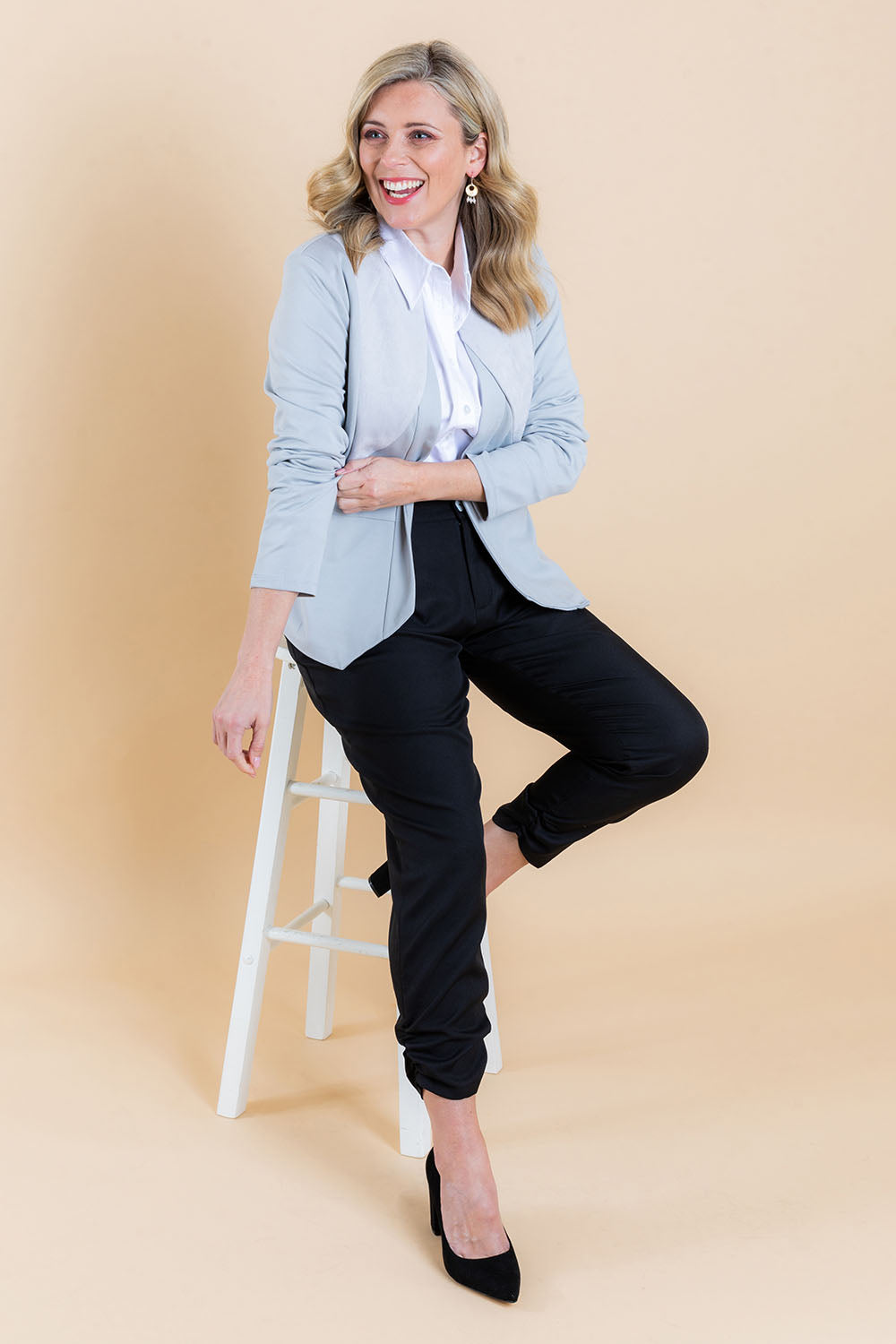 Model Brooke wearing size 10 of The Best Seller Pant in colour JetBlack (Black), from the front, showing the whole outfit